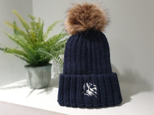 Navy blue chunky beanie with detachable bobble in brown faux fur.   The Cally Collection logo is in white in the centre of the front fold.