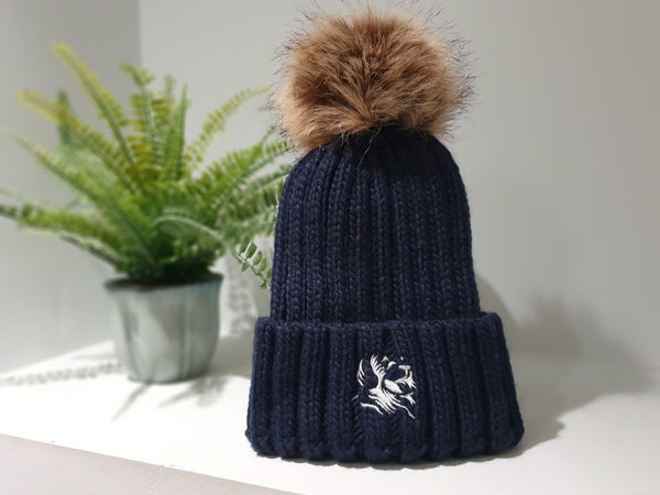 Navy blue chunky beanie with detachable bobble in brown faux fur.   The Cally Collection logo is in white in the centre of the front fold.