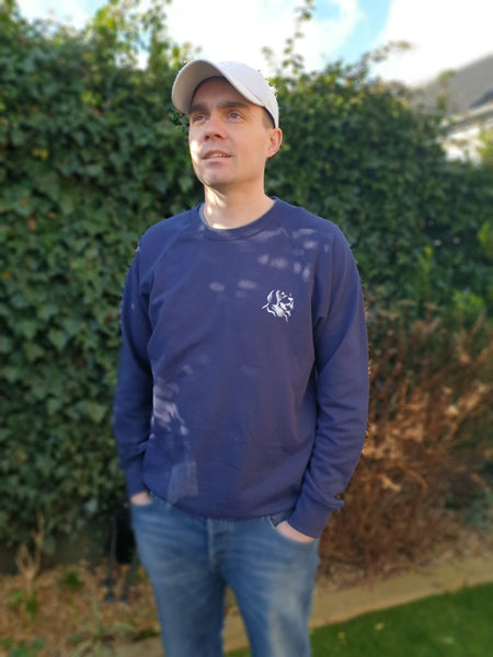 Photo of man wearing a navy sweatshirt with The Cally Collection logo in white in the top left corner.   The man is also wearing a light grey air mesh cap with The Cally Collection logo in white on the front panel.