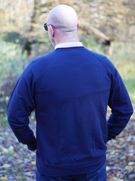 Photo of back of man wearing a navy sweatshirt from The Cally Collection.