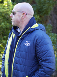 Photo of man wearing a navy hoody from The Cally Collection, with a navy lightweight jacket with lime trim and The Cally Collection logo in white in the top left corner.