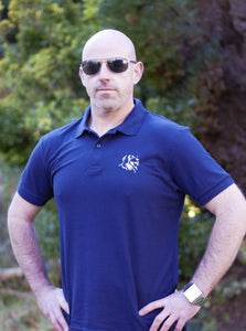 Photo of man wearing navy polo shirt with The Cally Collection logo in white in the top left corner.