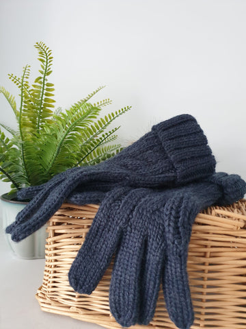 Photo of a pair of cable knit gloves in navy.